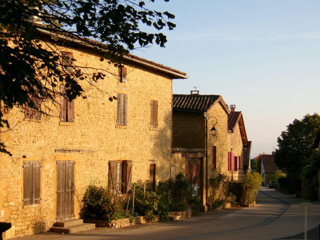 France Explore a picturesque French village with rustic architecture under a golden sunset.