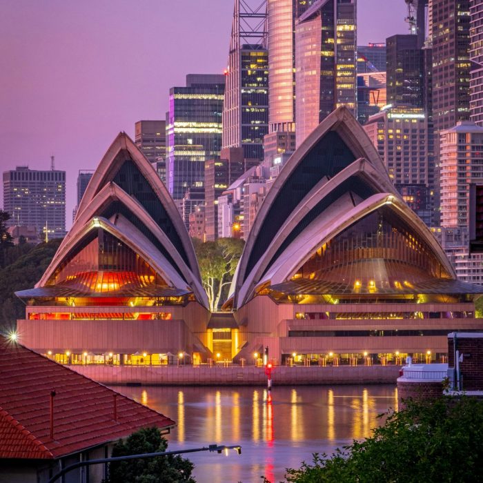 Twilight view of Sydney Opera House against the city skyline, NSW, Australia.