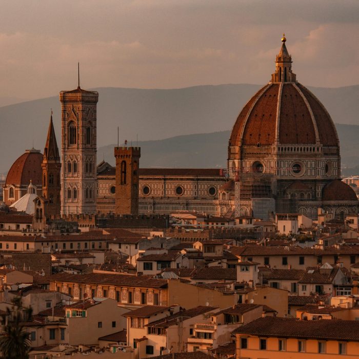 Capture the stunning Florence Cathedral and cityscape in the warm glow of sunset.